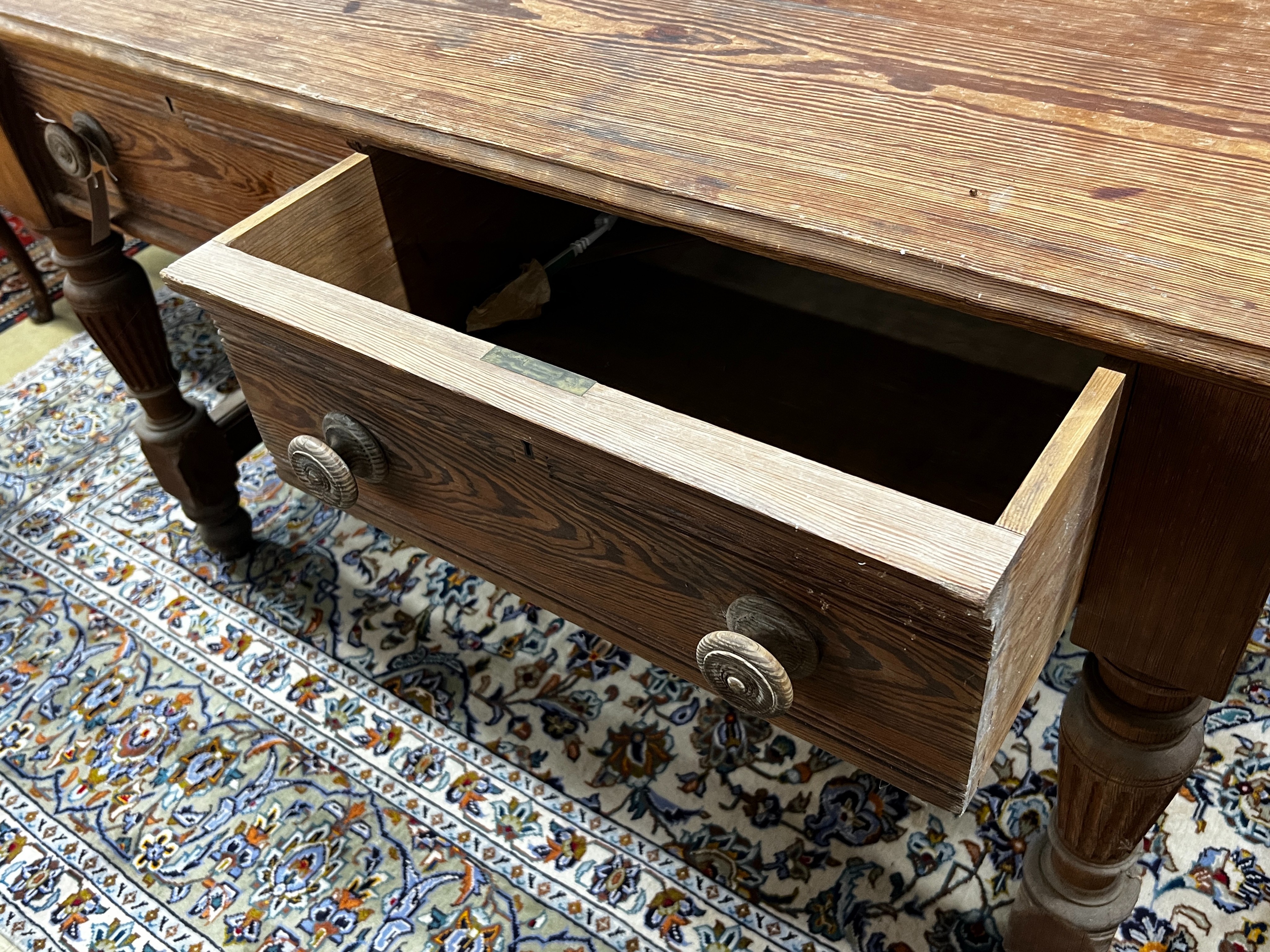 A Victorian stained pitch pine two drawer serving table by repute from Balmoral Castle kitchens, length 136cm, width 76cm, height 84cm